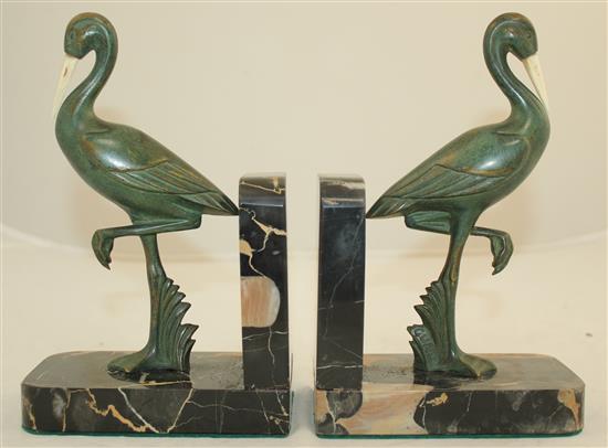 A pair of French Art Deco bronze and ivory stork bookends, 7.5in.